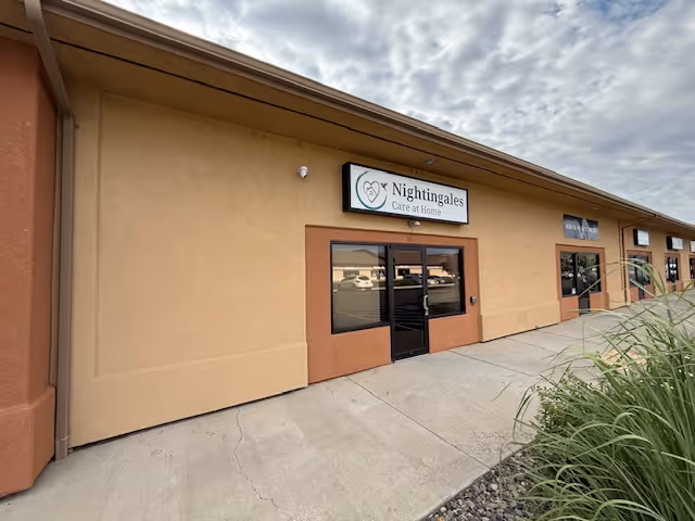 Exterior view of Nightingales Care At Home building with entrance and sign.
