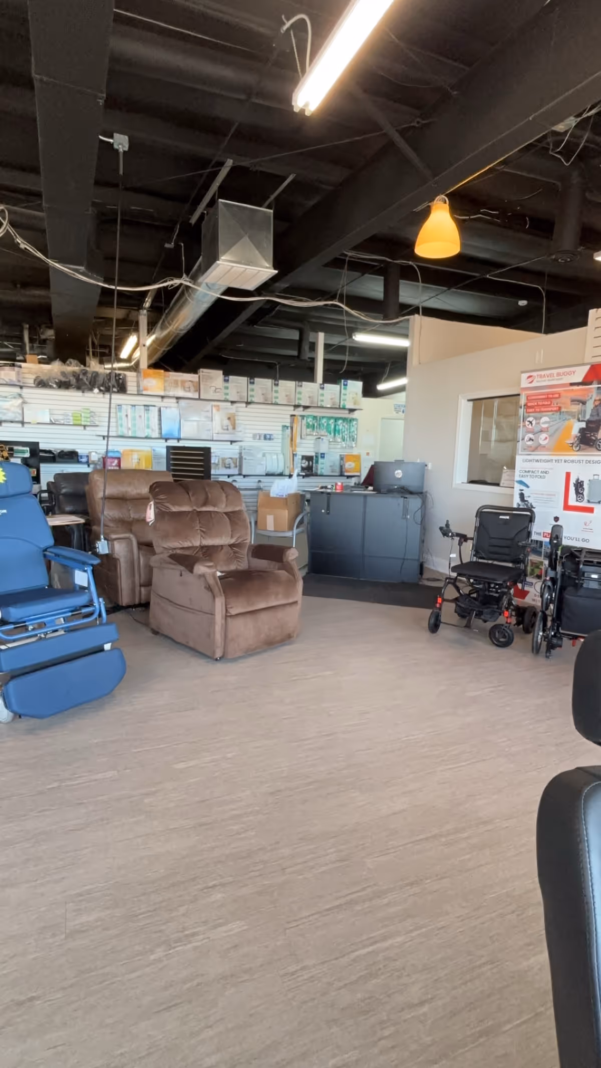 Indoor showroom with mobility chairs, wheelchairs, and medical equipment shelves.