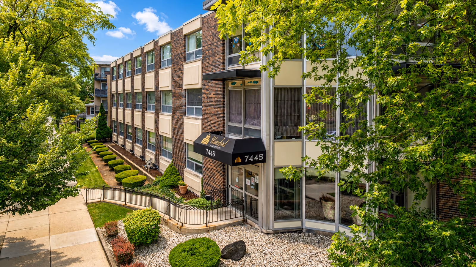 Exterior view of The Waterford Care Center building with glass entrance and landscaping