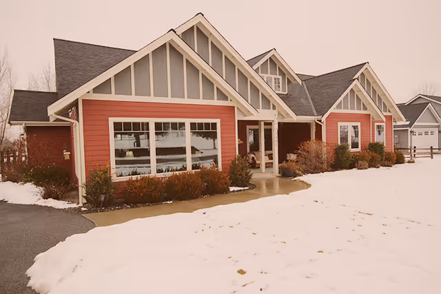 Snowy exterior view of Tuscany Cottage Adult Family Home building
