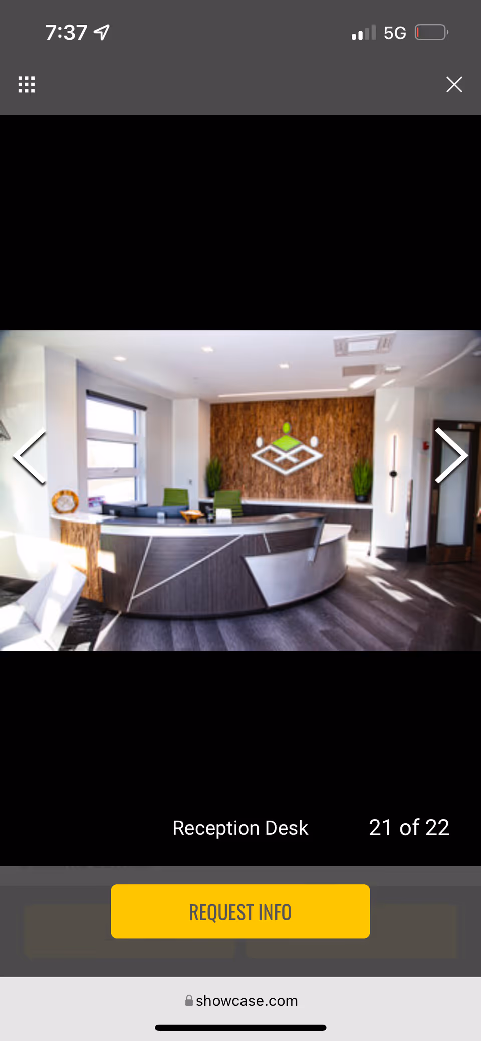 Modern reception desk in a spacious lobby with wood accent wall.