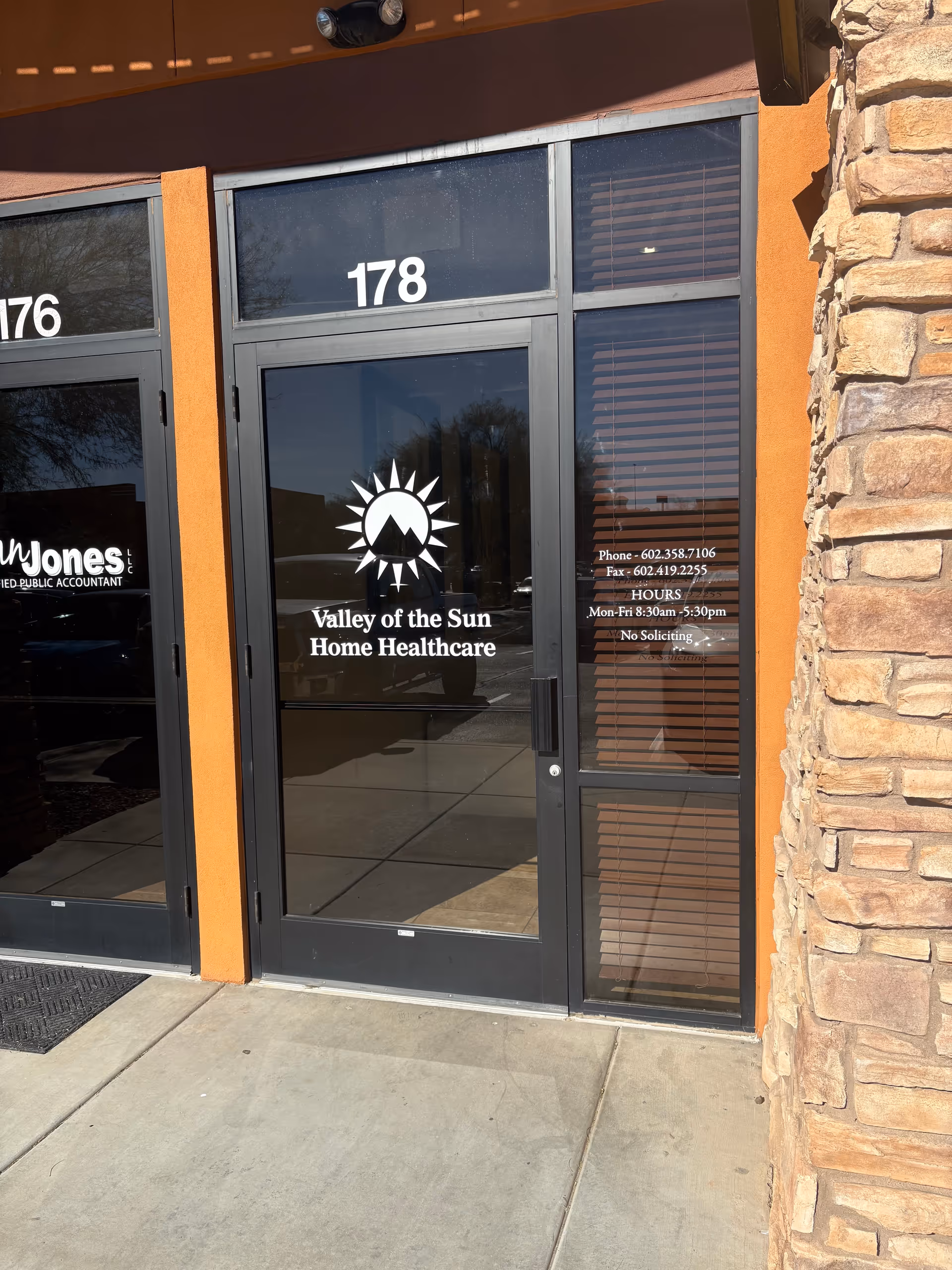 Glass entrance door with Valley of the Sun Home Healthcare logo and unit number 178.