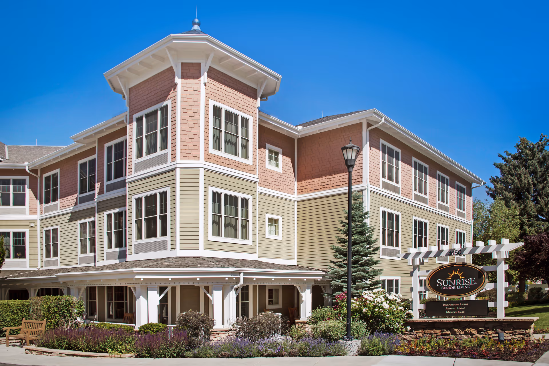 Sunrise at Holladay exterior: a multi-story senior living building with a sign and landscaped grounds.
