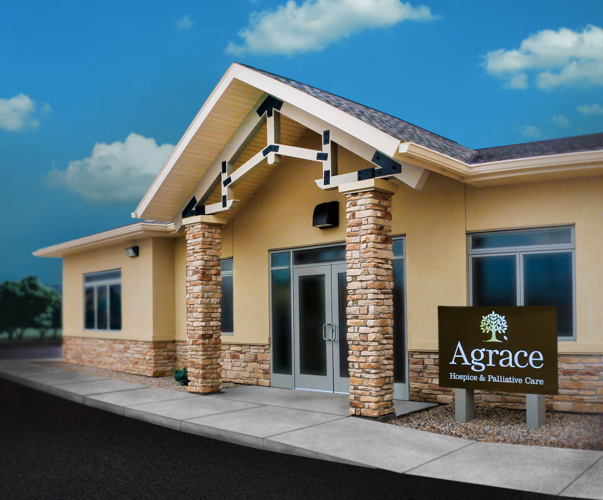 Front exterior of Agrace hospice building with stone columns and a large sign