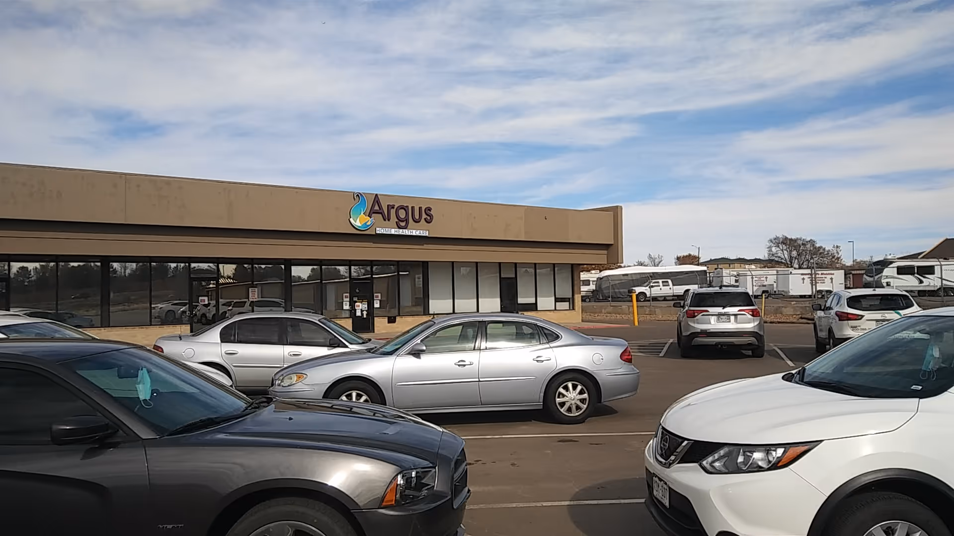 Front exterior of Argus Homecare Inc building with cars in the parking lot.