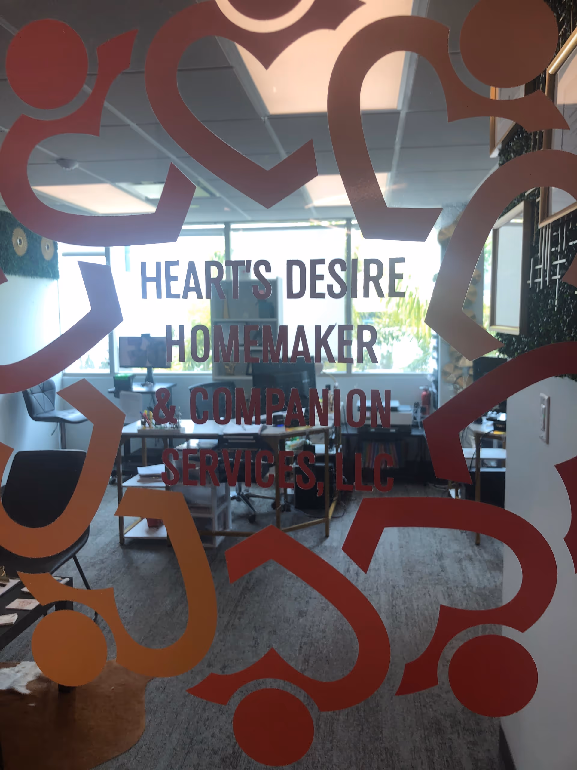 Office interior visible through glass door with Heart's Desire Homemaker and Companion Services sign