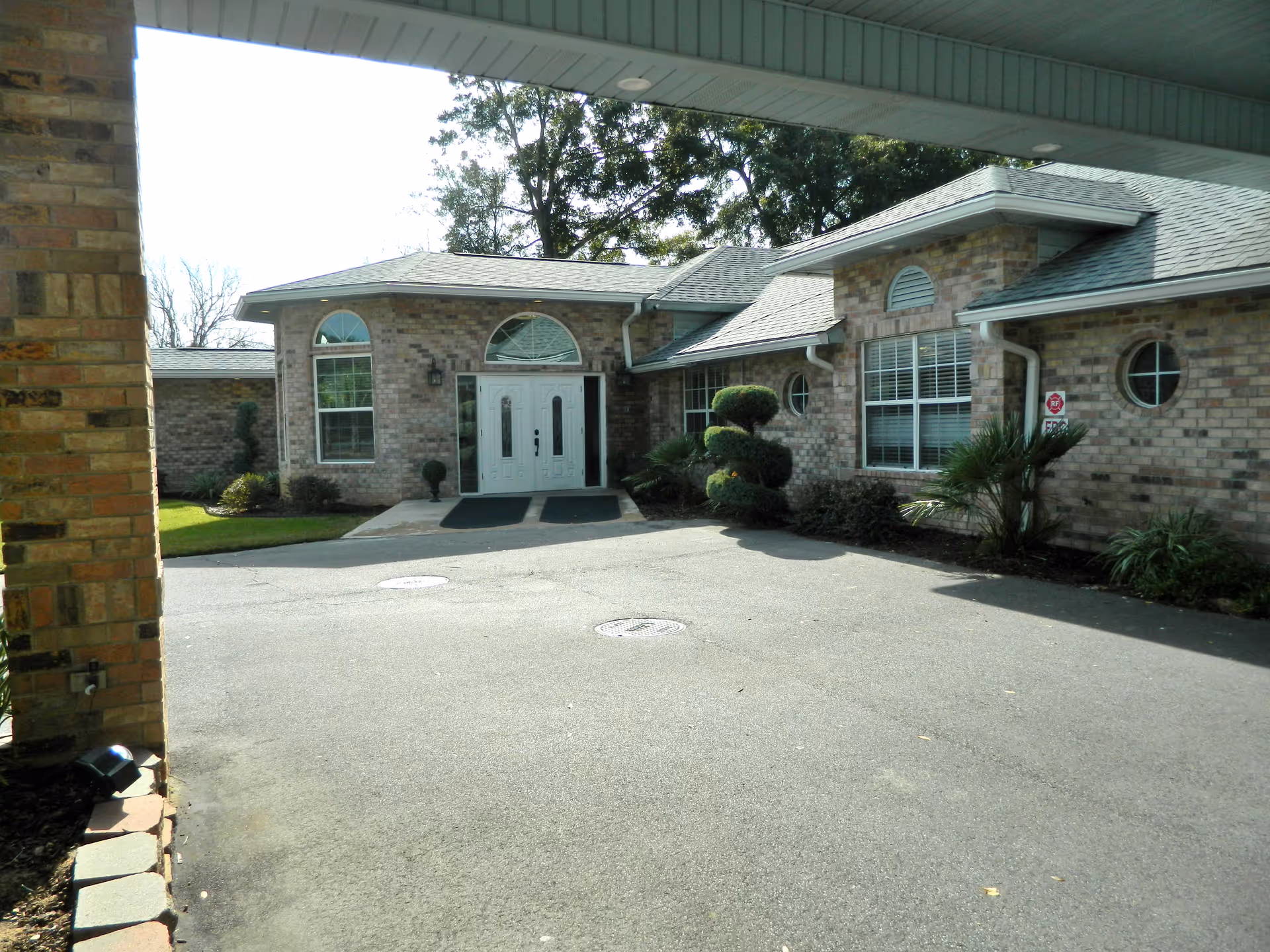 Windermere Memory Care facility entrance with double doors and landscaped surroundings