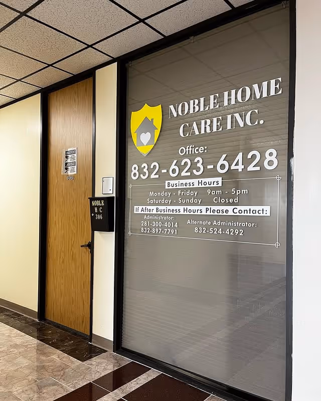 Interior hallway featuring Noble Home Care Inc. signage on a large glass window and door.
