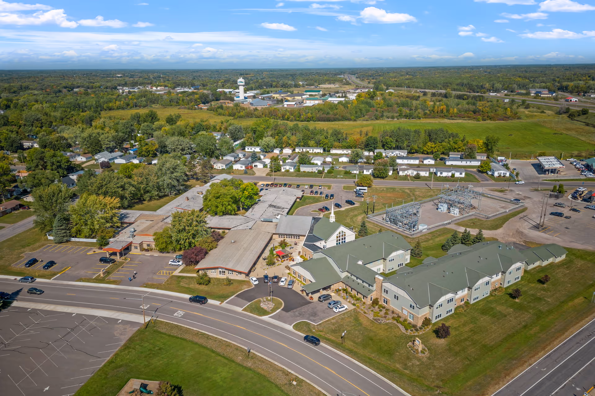 Aerial view of Elim Home Milaca campus with green roofed buildings and parking.