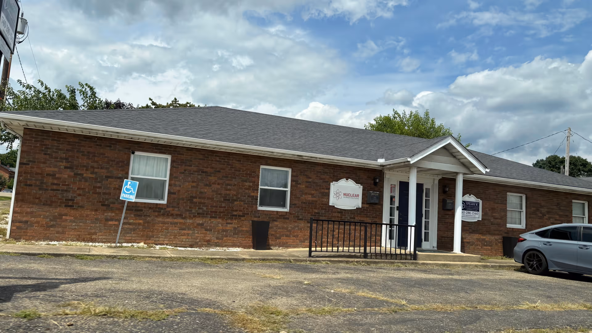 Brick single story building with entrance and Nuclear Worker Solutions sign.