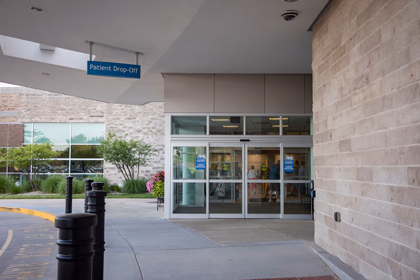 Schneck Medical Center Home Health entrance with glass doors and a Patient Drop-Off sign.