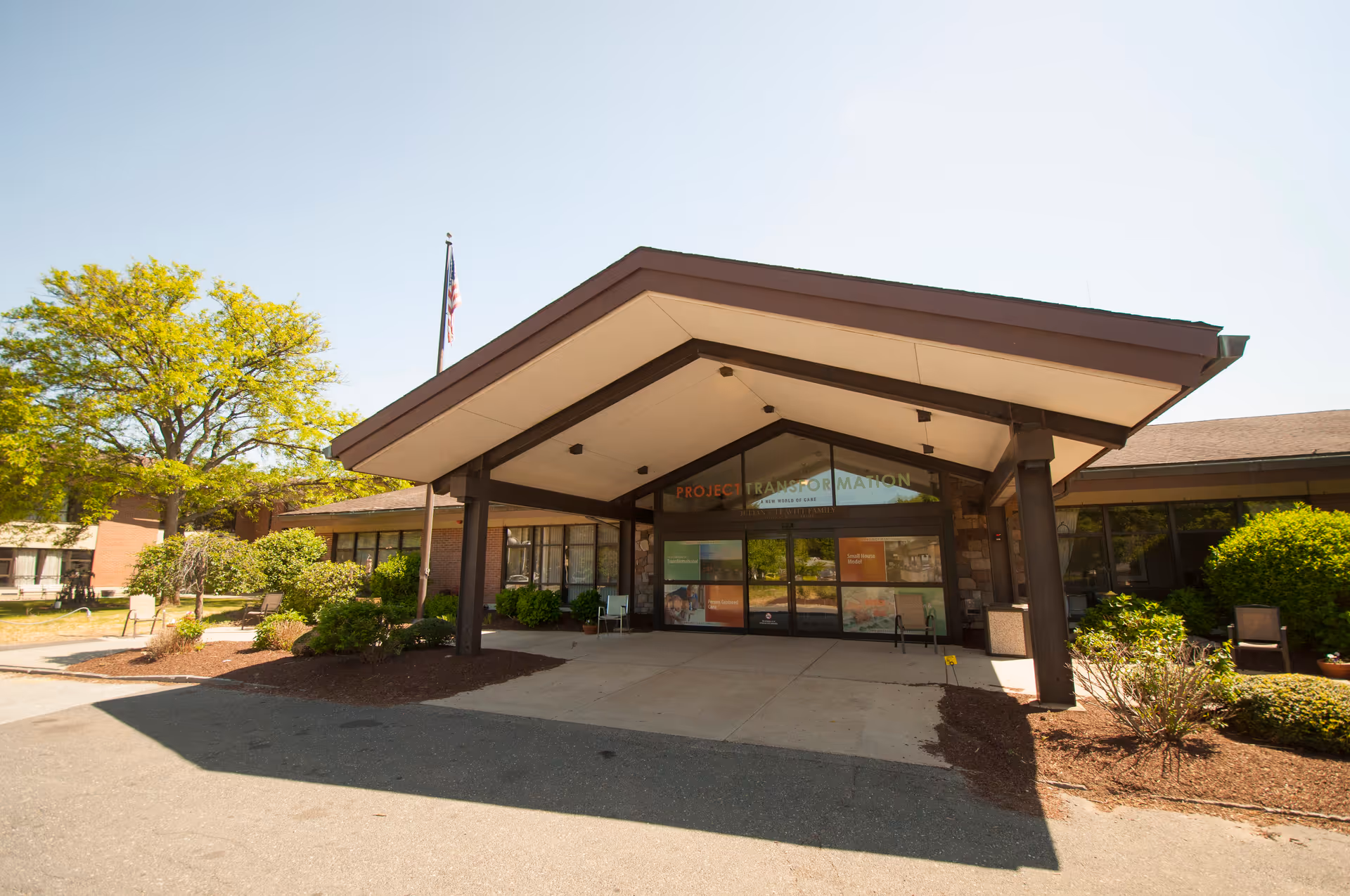 Front entrance of Leavitt Family Jewish Home with a wide canopy and glass doors.