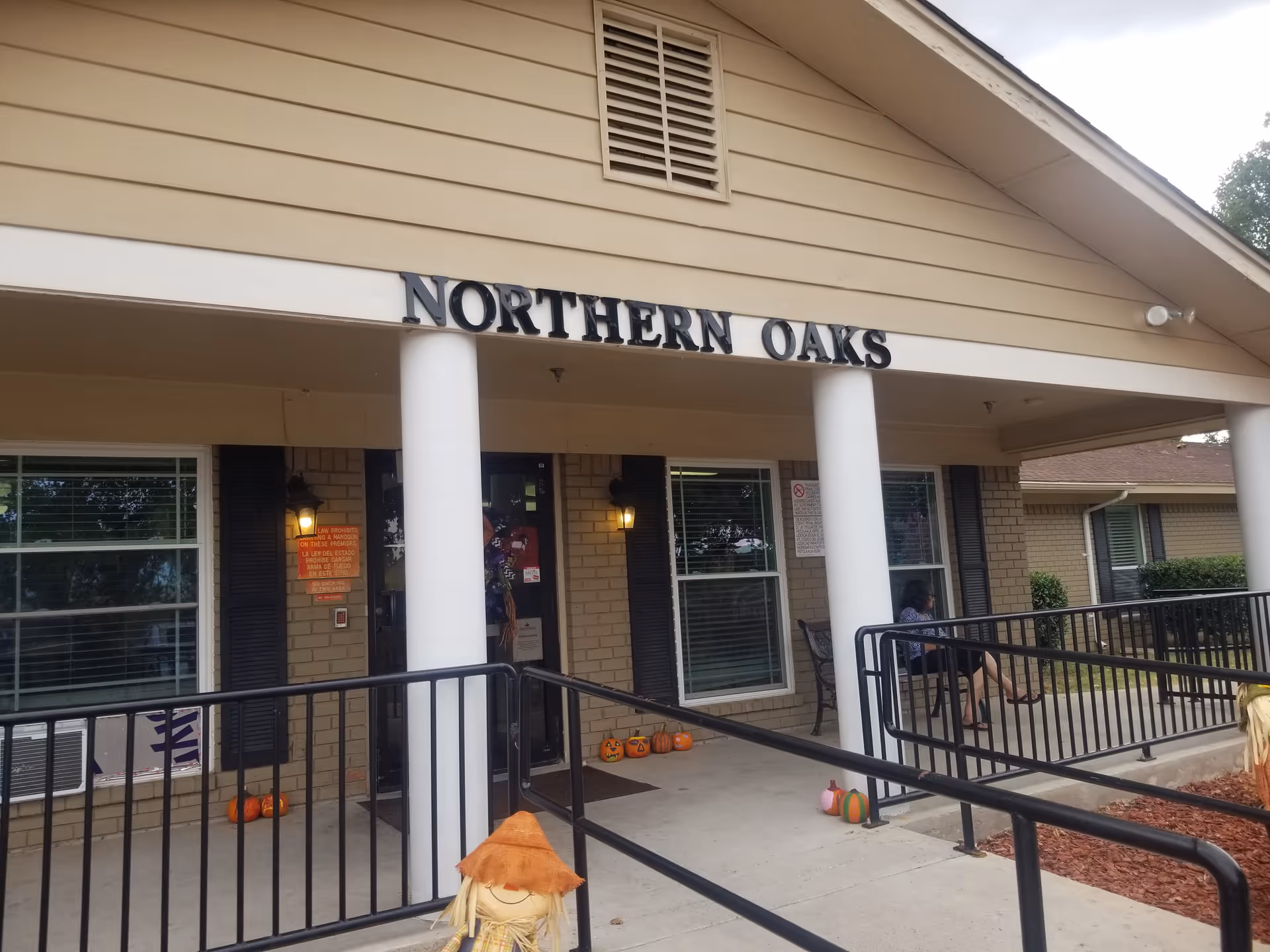 Front exterior of Northern Oaks Living & Rehabilitation Center with pumpkins on the walkway.