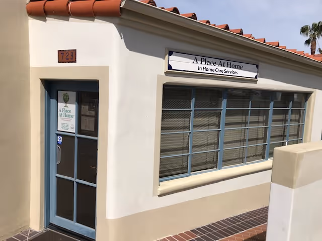 Exterior of A Place At Home South Bay building with glass door and large windows.