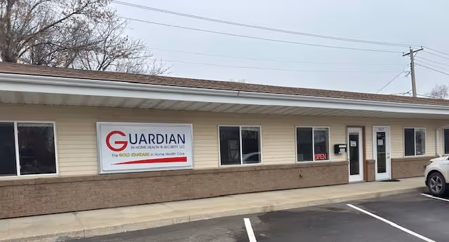 Exterior view of Guardian In Home Health & Security building with parking.
