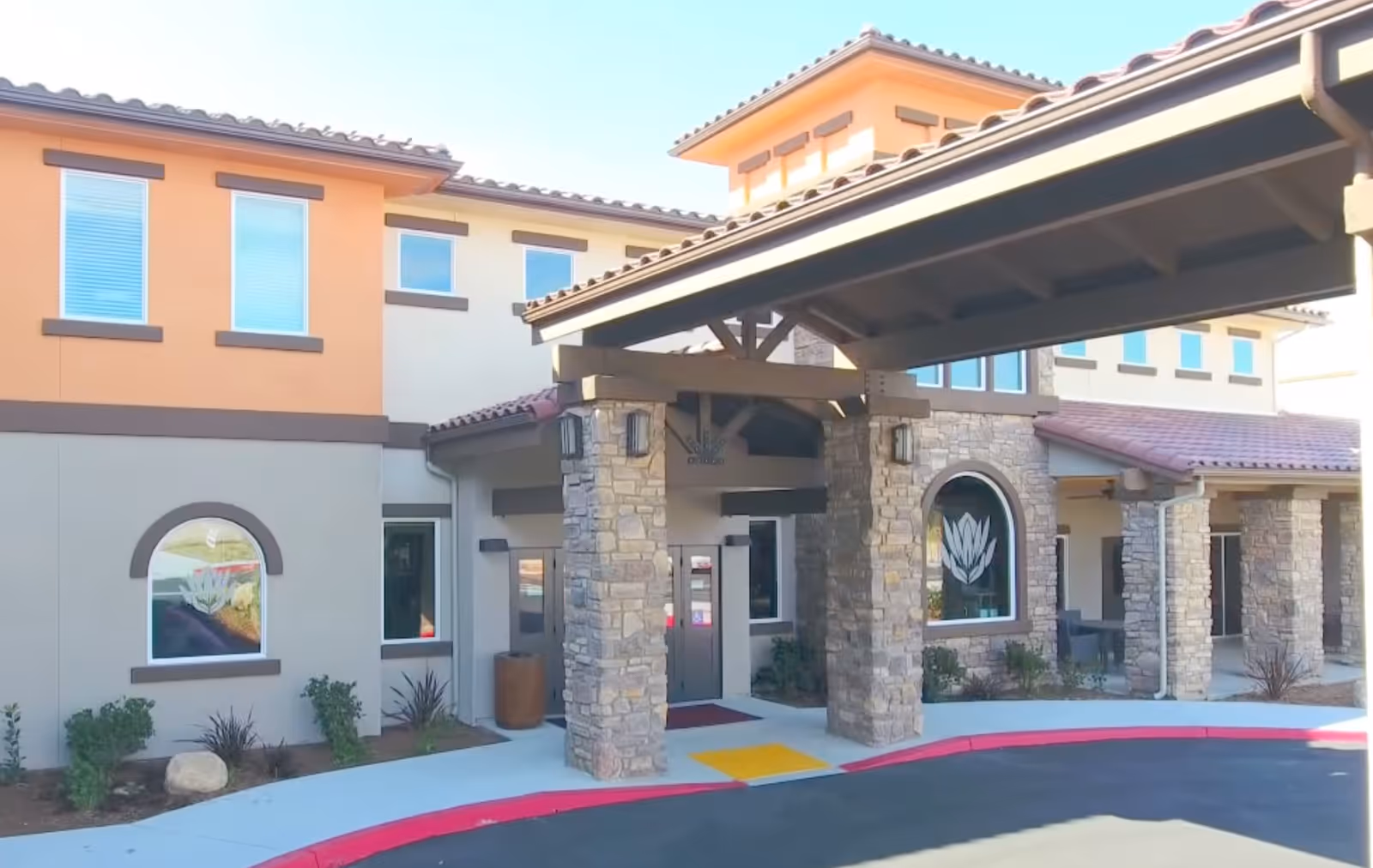 Exterior view of Vineyard Ranch at Temecula entrance with stone pillars and covered entry.