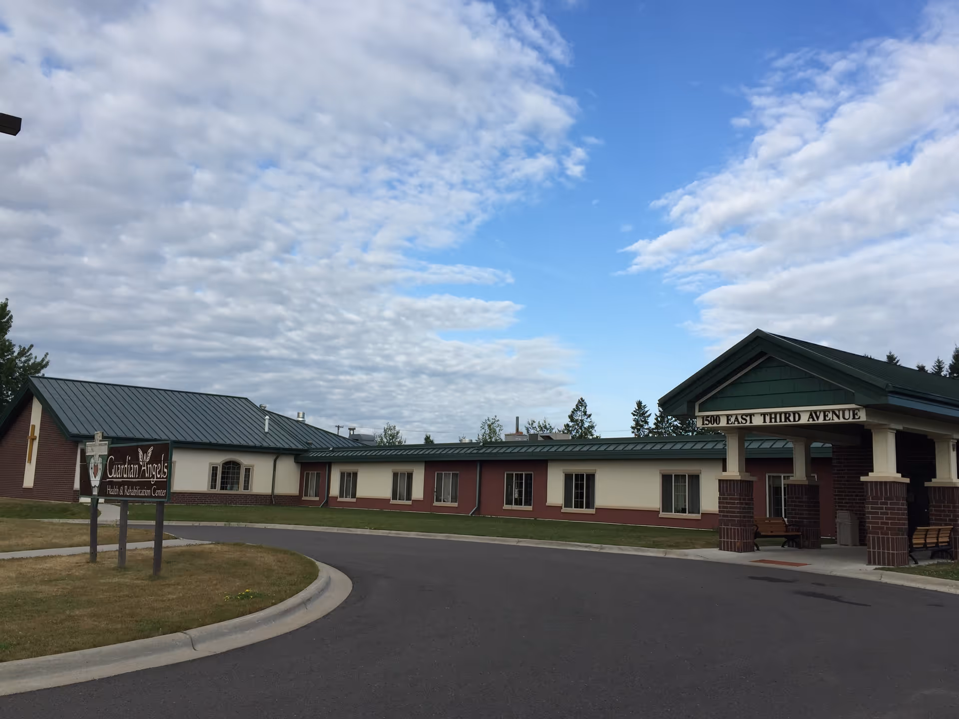 Exterior view of Guardian Angels Health and Rehab Center with entrance canopies.