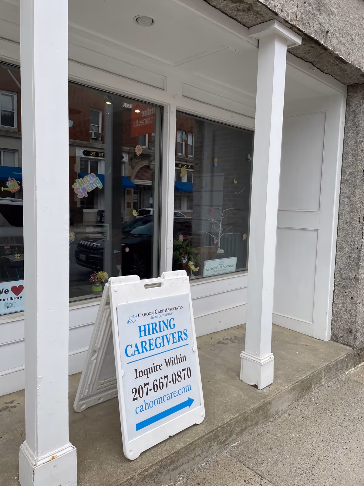 Front of Cahoon Care Associates storefront with a Hiring Caregivers sidewalk sign.