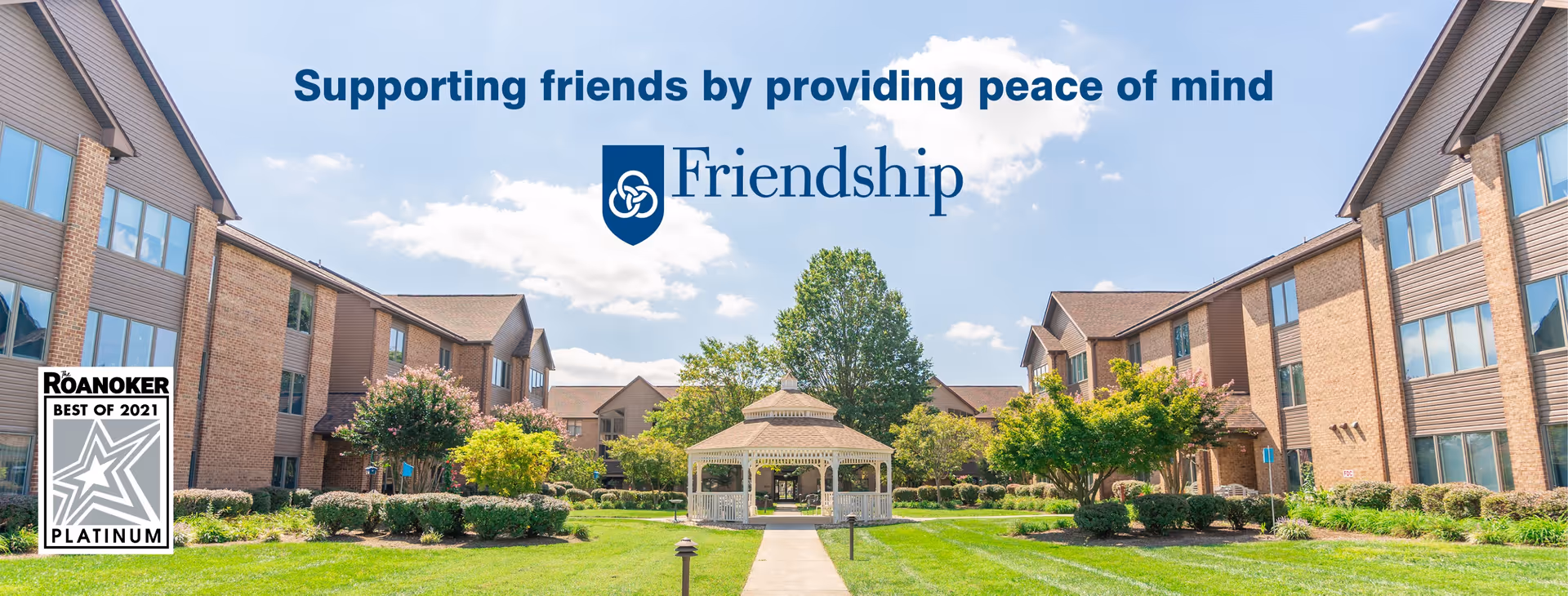 Exterior view of a senior living campus with a central gazebo courtyard and well-kept lawn.