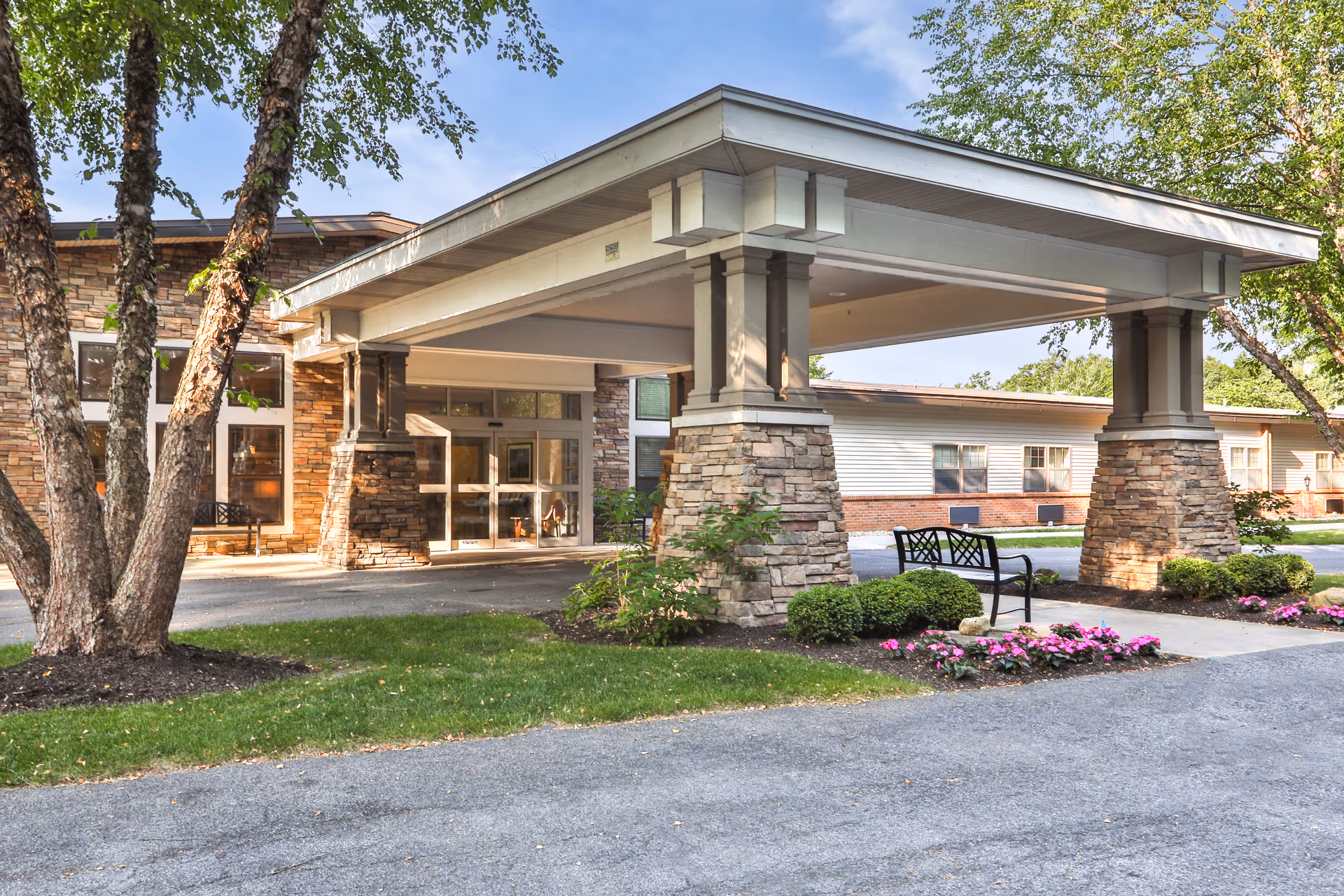 Front exterior view of Peregrine Senior Living at Guilderland with entrance and landscaping