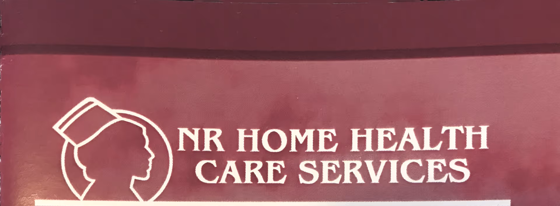 Maroon sign reading NR HOME HEALTH CARE SERVICES with a silhouette logo