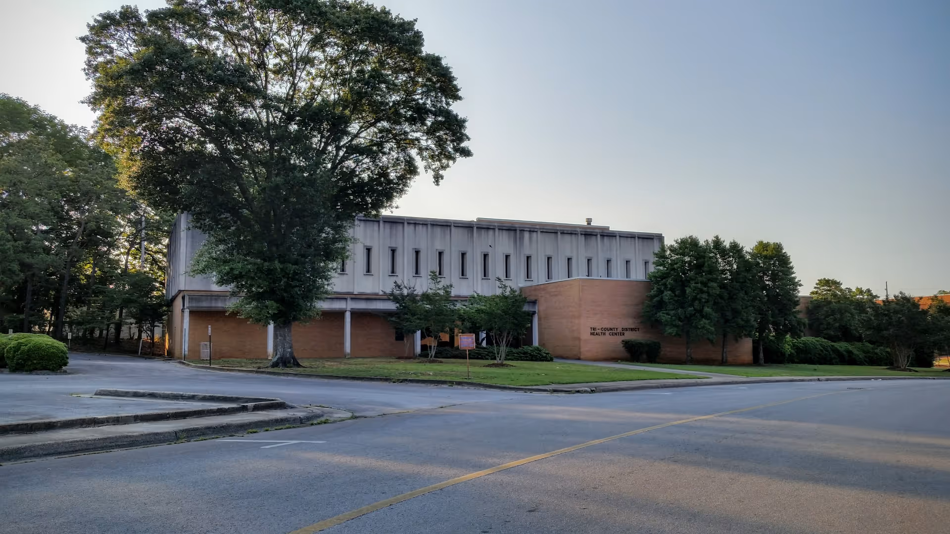 Exterior view of Morgan County Health Department building along a street with trees