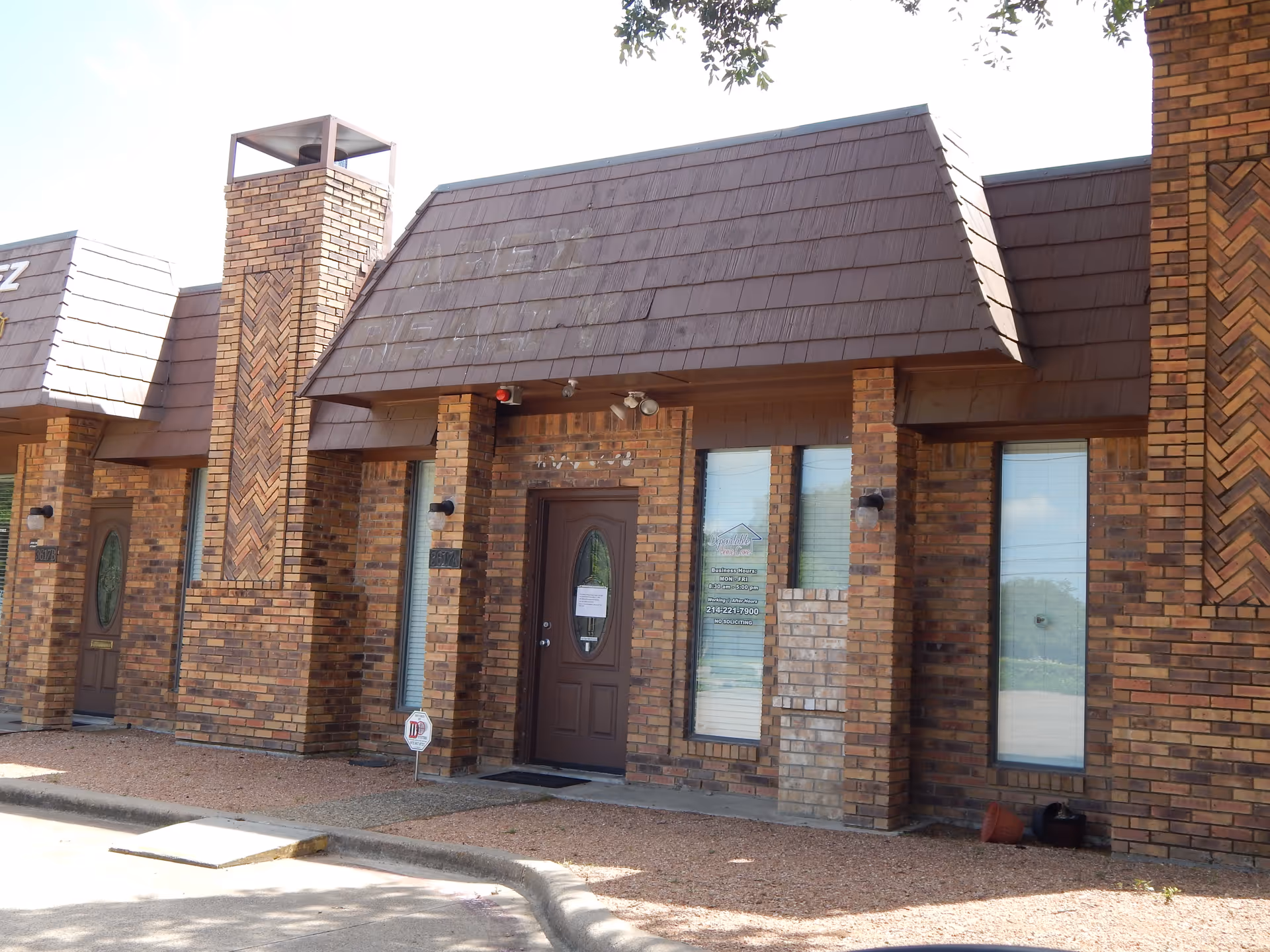 Brick exterior of a senior care facility with doors and windows.