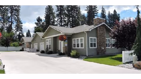 Exterior view of Sunshine Adult Family Home I with gray siding and a paved driveway.