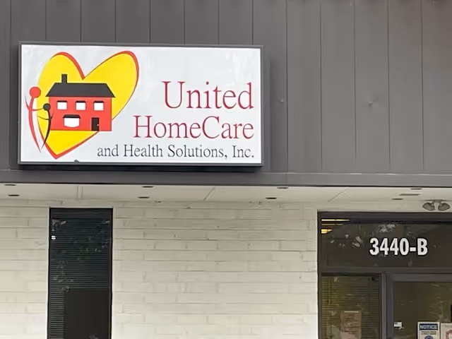 Exterior of United HomeCare and Health Solutions storefront sign on a gray building