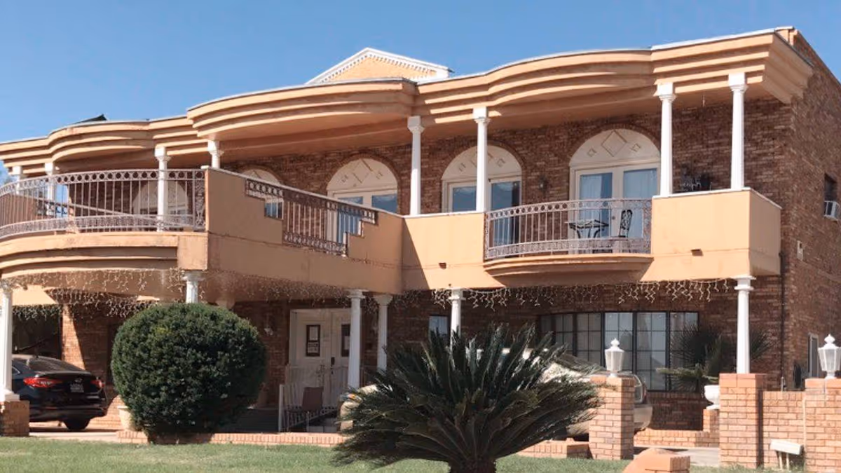 Exterior view of Sunshine Care Home II with balconies and brick facade.