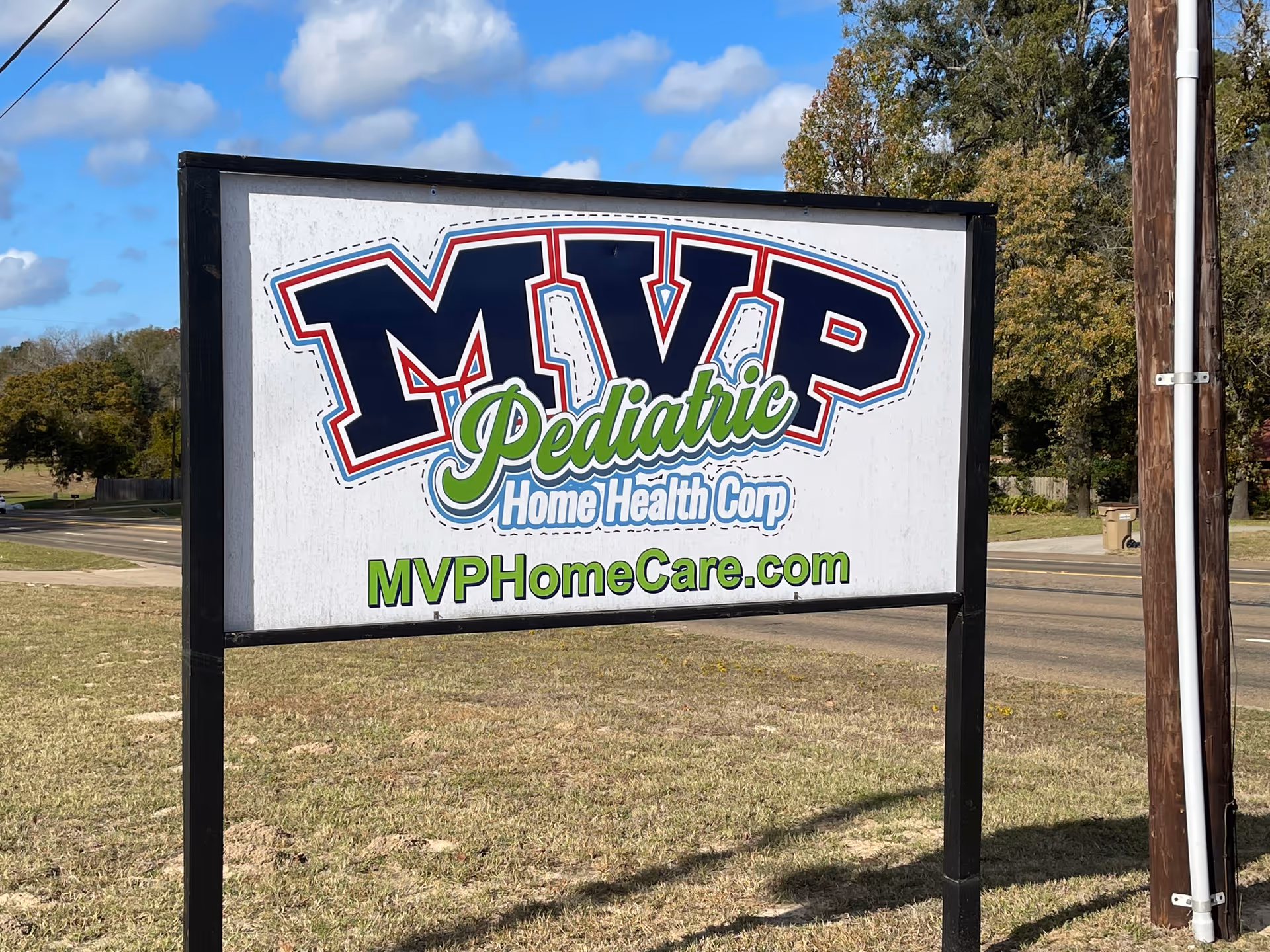 A large MVP Pediatric Home Health Corp sign on grass beside a road.