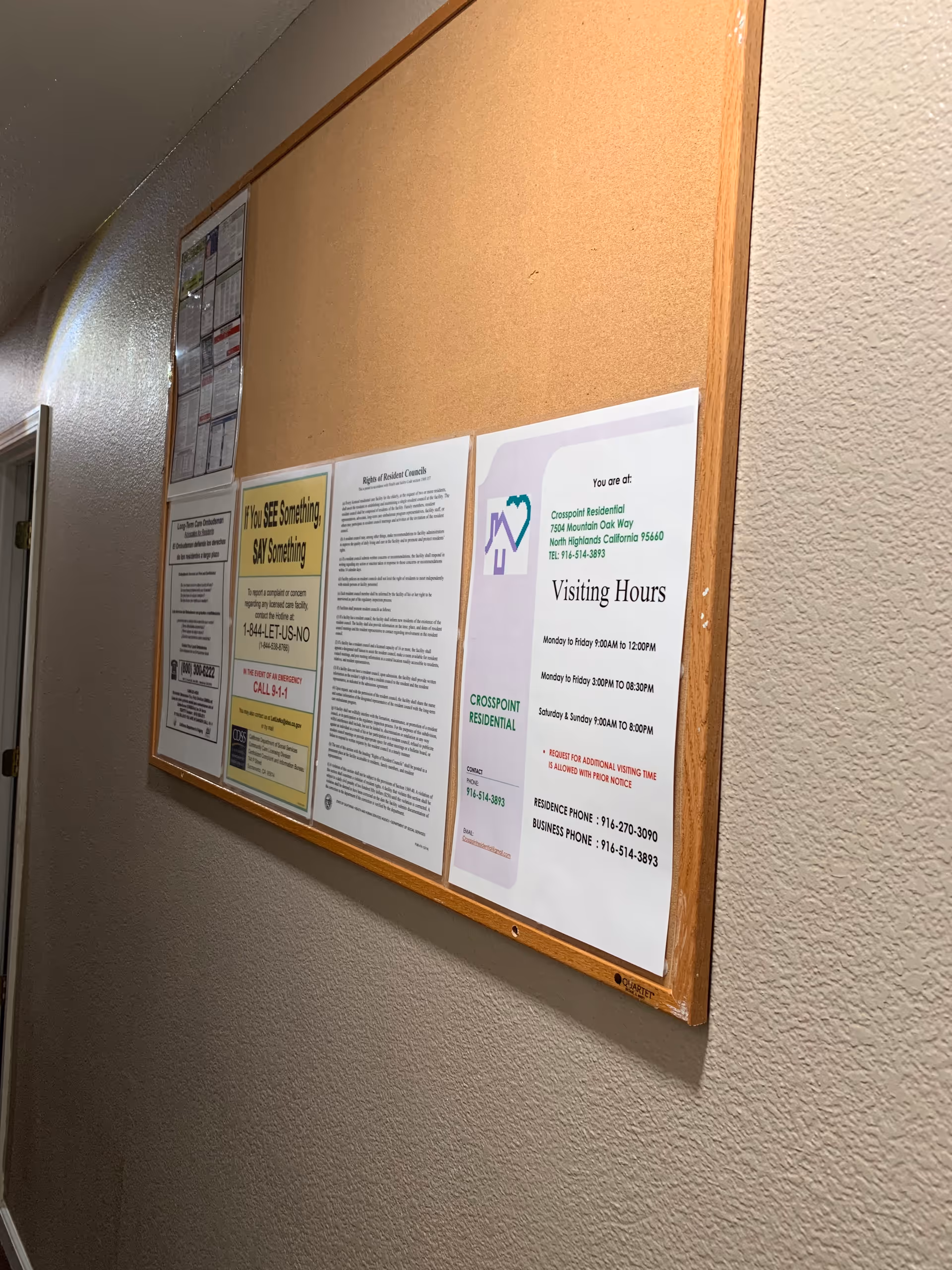 Interior hallway bulletin board with notices at Crosspoint Residential