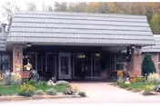 Front view of Norlite Nursing Center entrance with brick facade and landscaped garden.