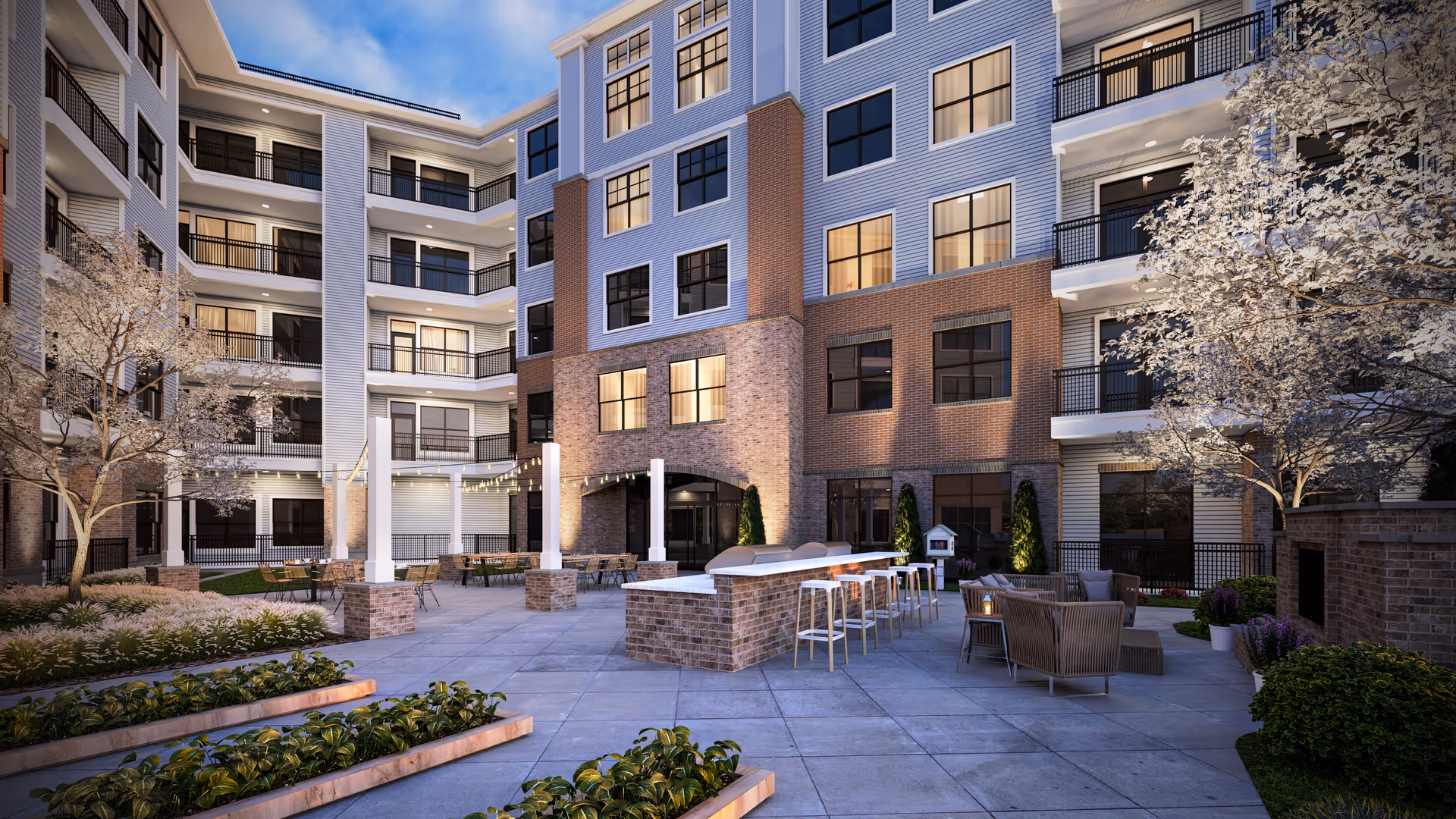 Outdoor courtyard of a multi-story senior living building with seating and balconies.