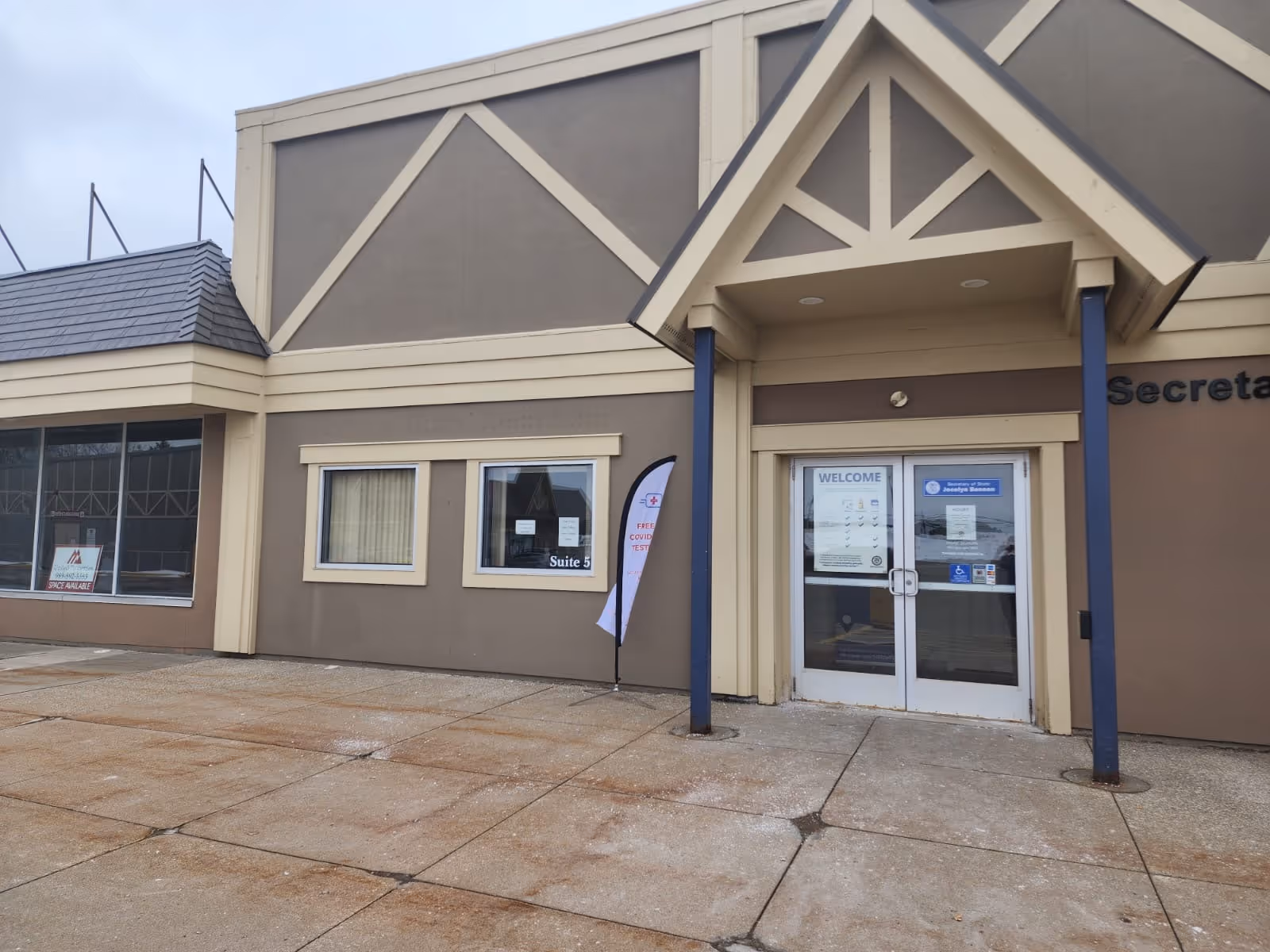 Exterior view of a FortisHealth facility entrance with glass doors and tan-brown facade.
