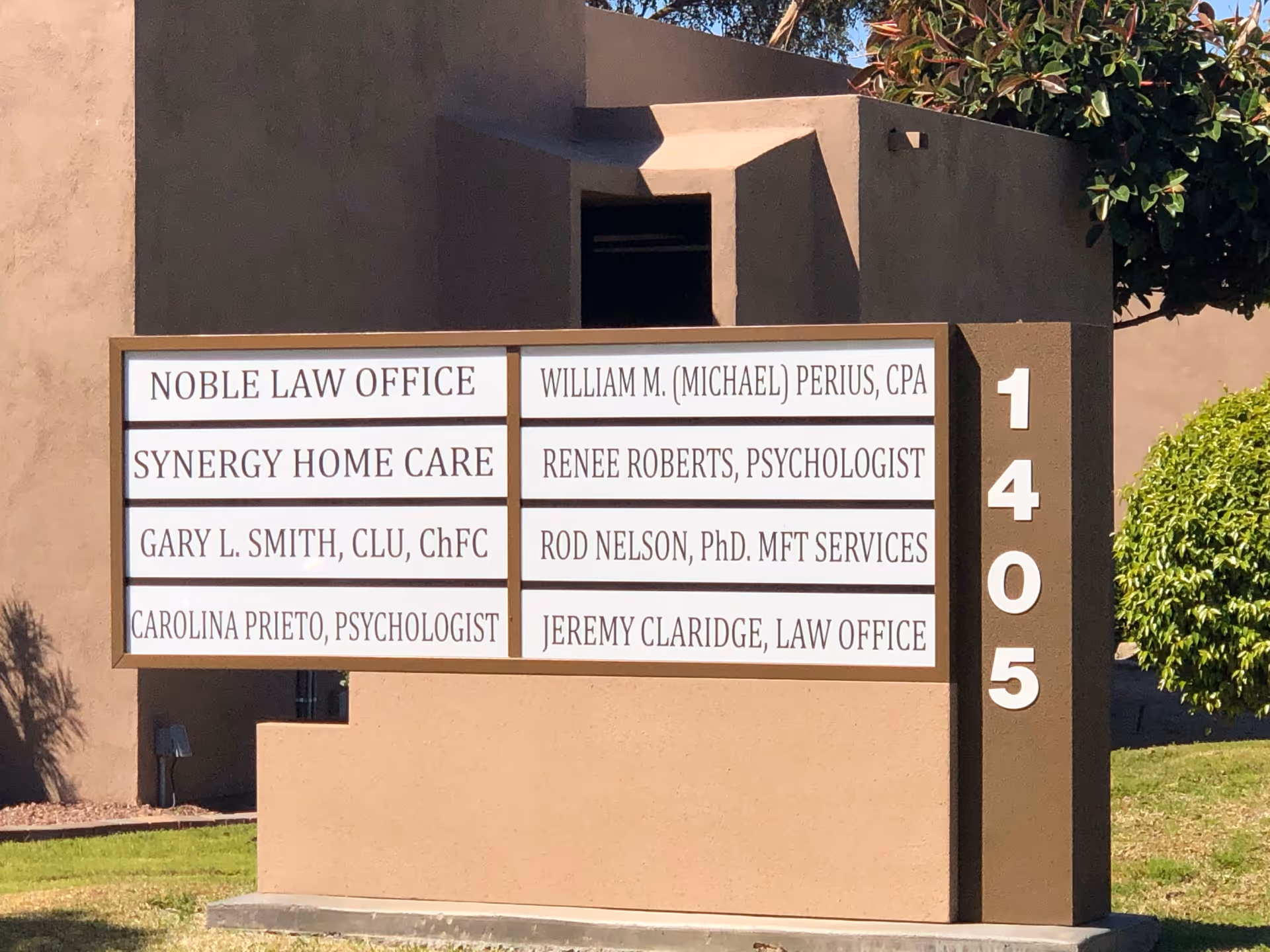 Exterior signboard displays multiple office names and the number 1405