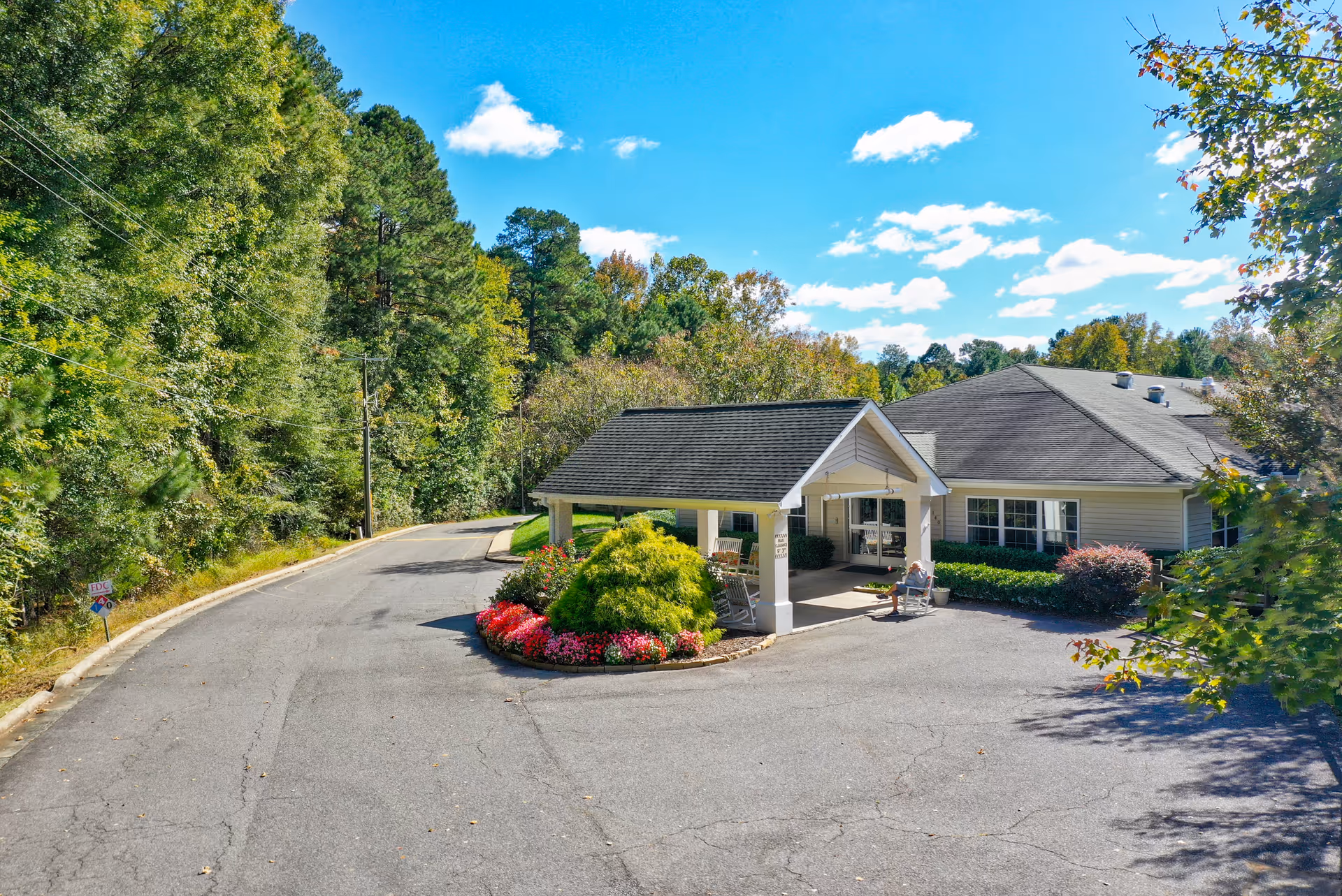 Exterior view of Cambridge Hills Assisted Living with driveway, entrance, and landscaping