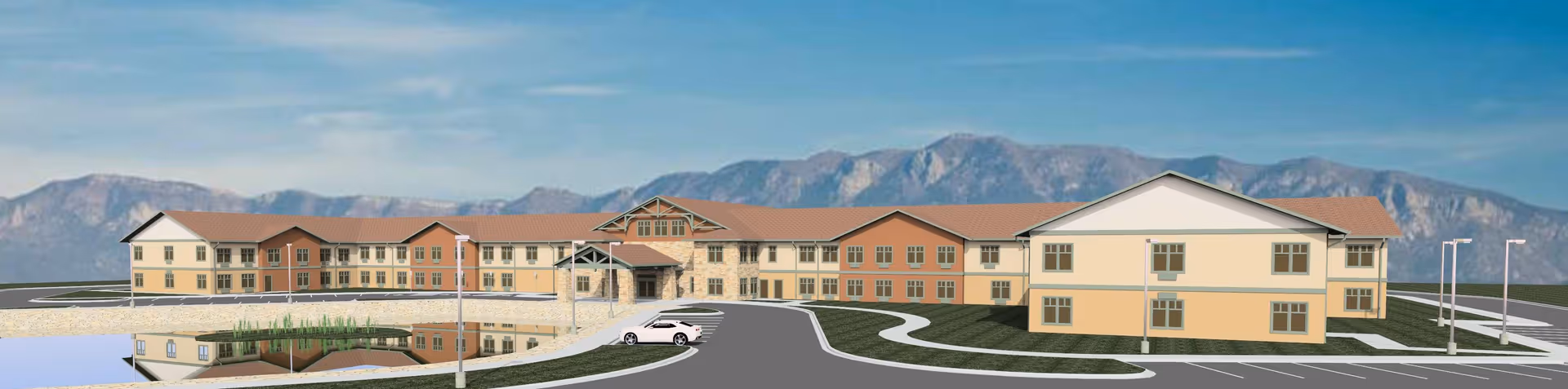 A large, multi-wing senior living facility exterior with curved driveway and water feature.