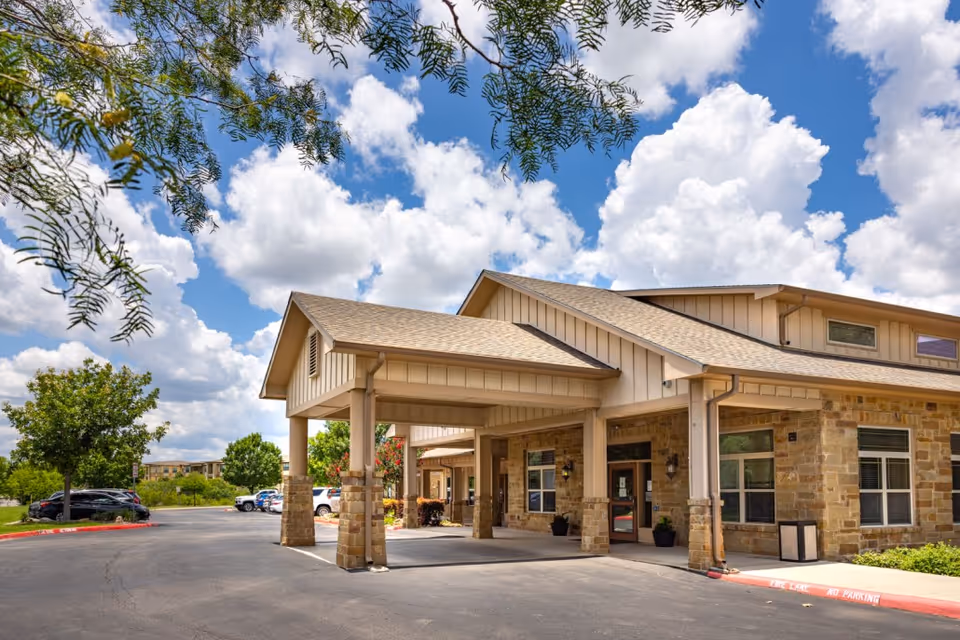 Sunny day exterior view of Lakeside Nursing and Rehabilitation Center entrance with covered drive.