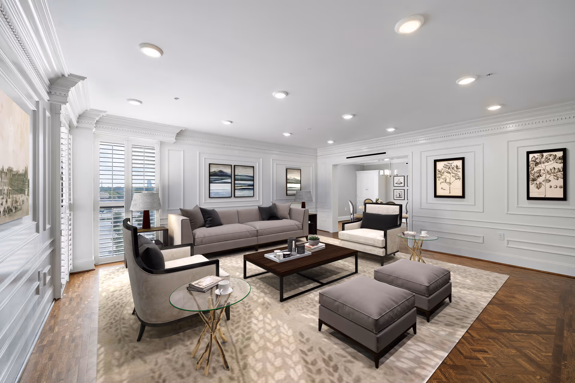 Bright, elegant living room with sofas, armchairs, a coffee table, and framed wall art.