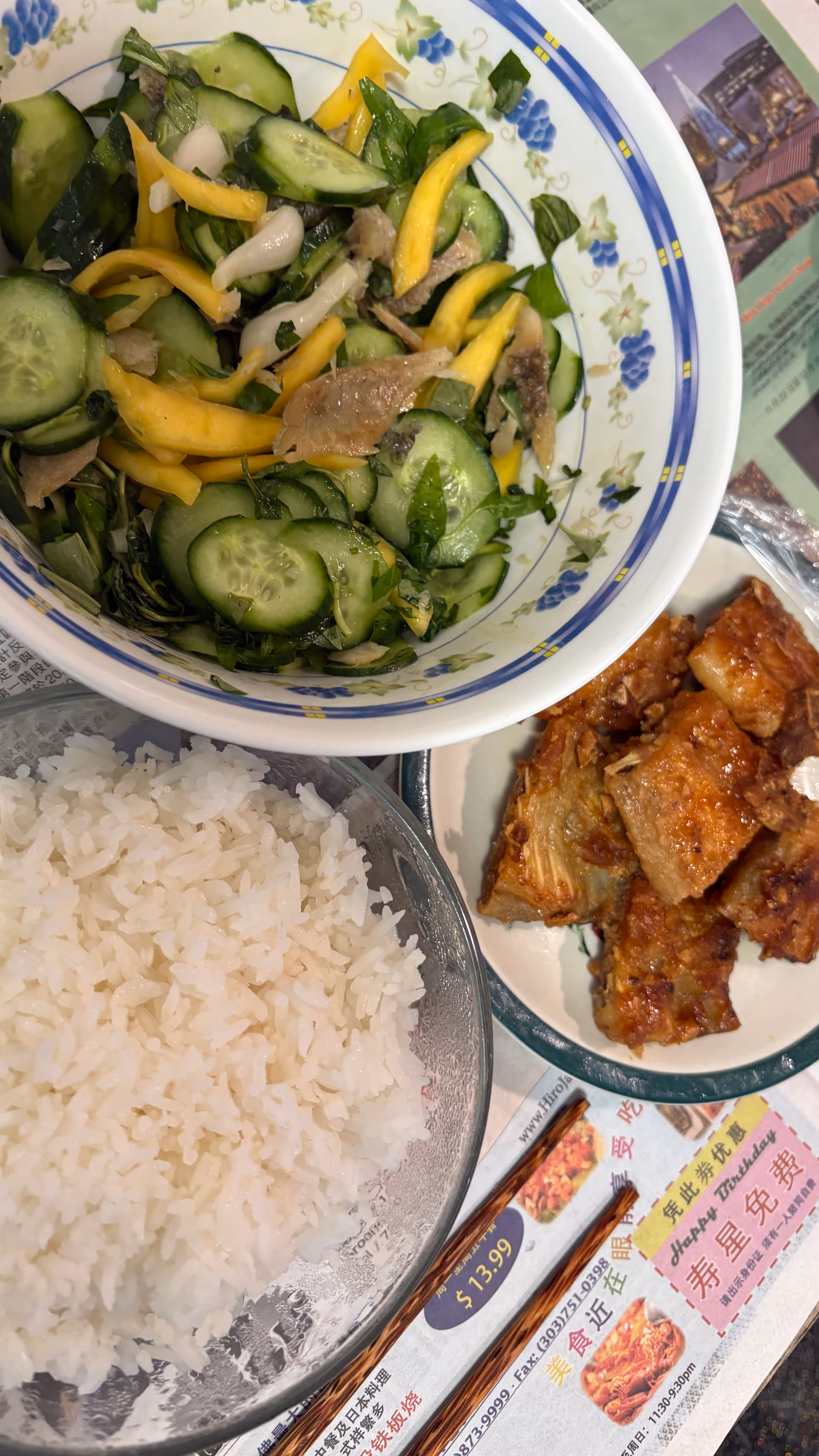 Assorted plated dishes, including rice and vegetables, on a dining table.