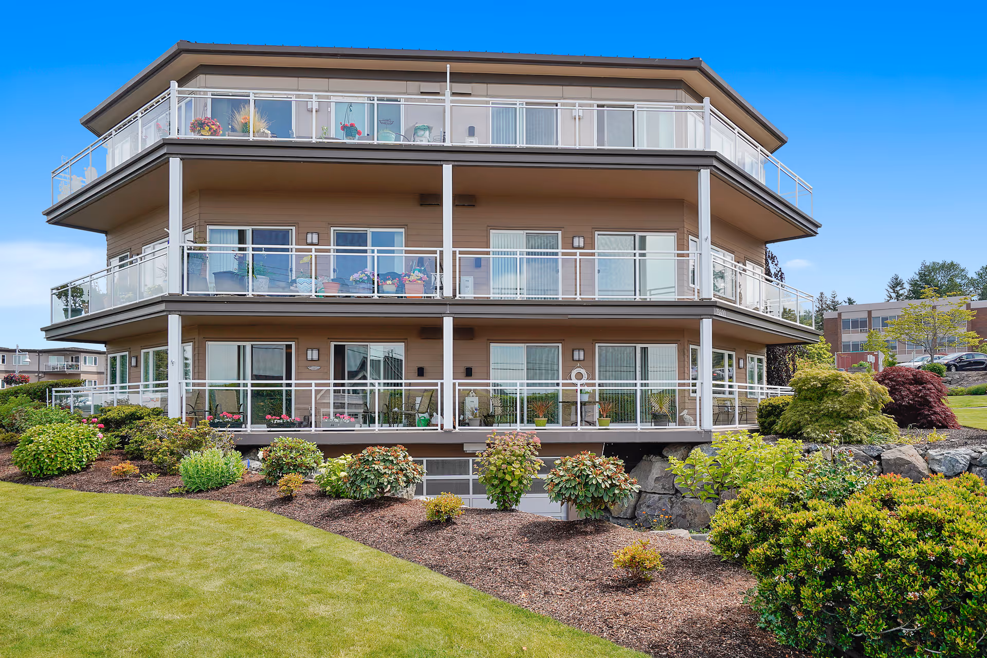 Three-story beige Judson Park Health Center building with glass balconies and landscaped lawn.