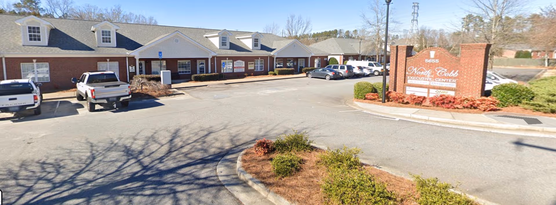 Exterior view of Mabry Medical Services LLC building with parking lot and sign.