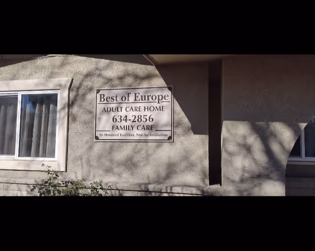 Exterior view of a beige building with a Best of Europe Adult Care Home sign