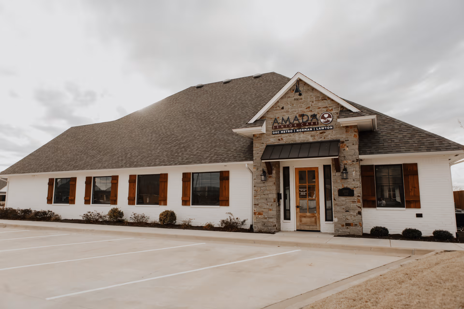 Amada Senior Care building exterior with stone entrance and empty parking lot