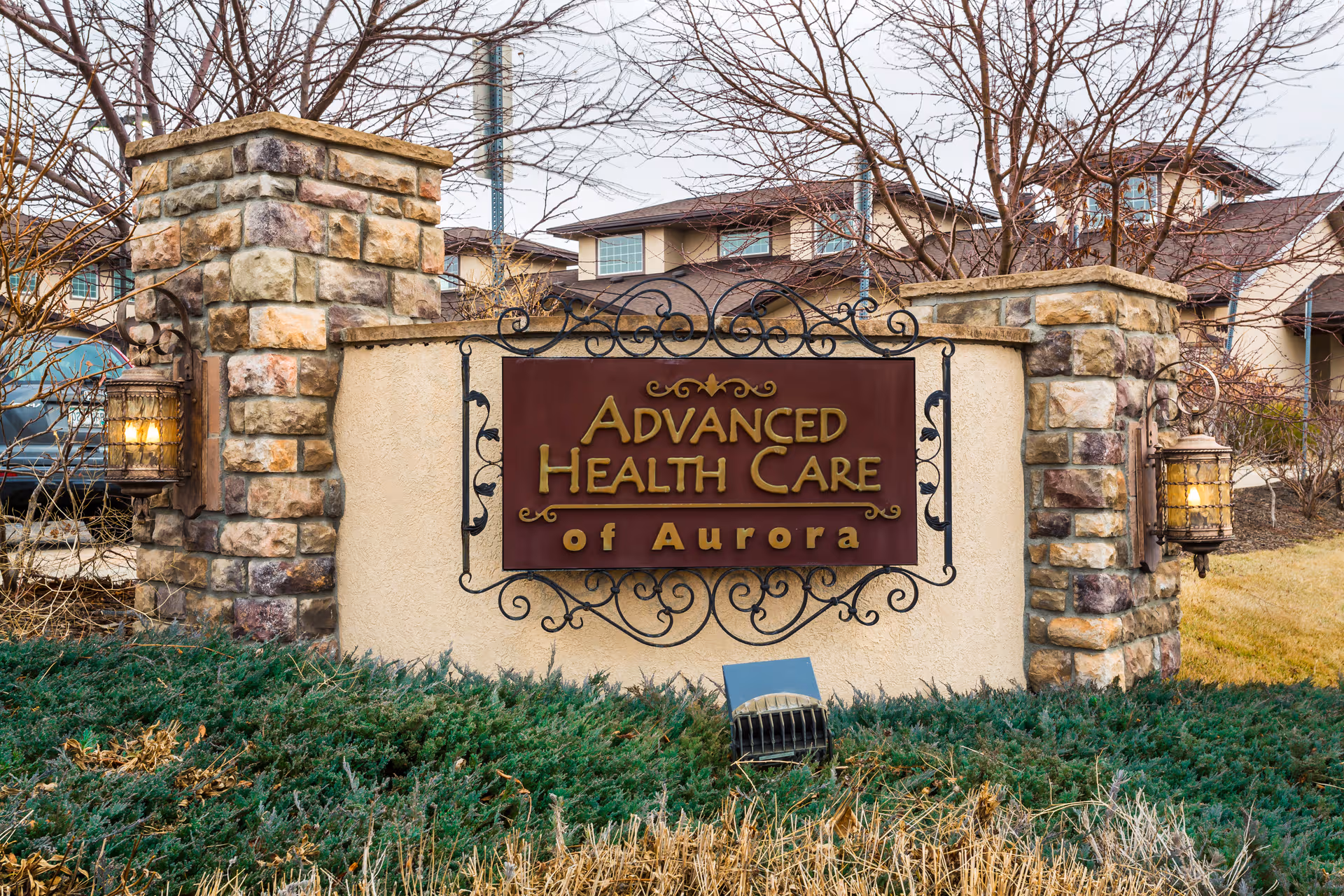 Stone entrance sign for Advanced Health Care of Aurora with iron decorative frame