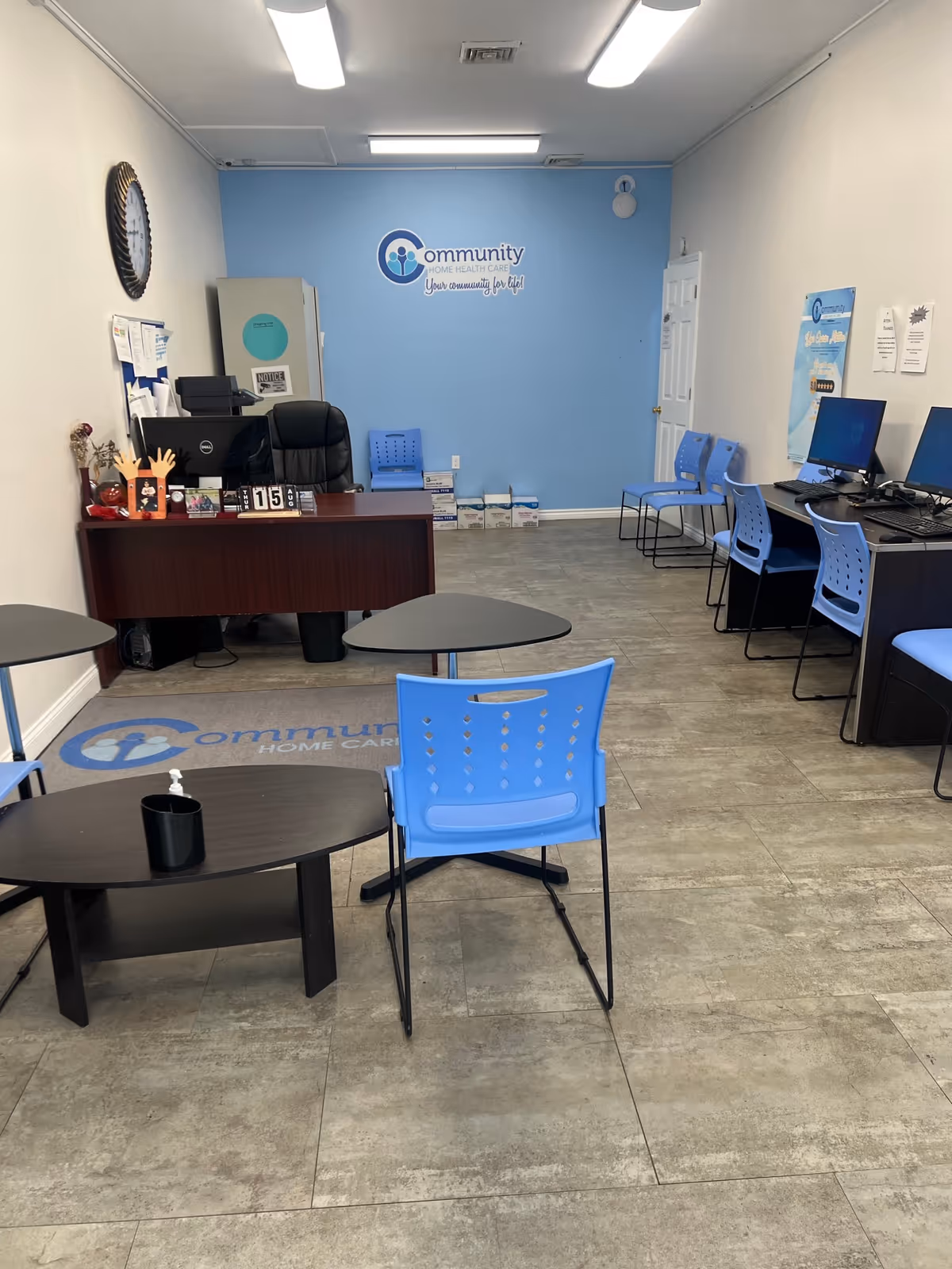 Reception area of Community Home Health Care Recruiting Office with blue walls and computers.