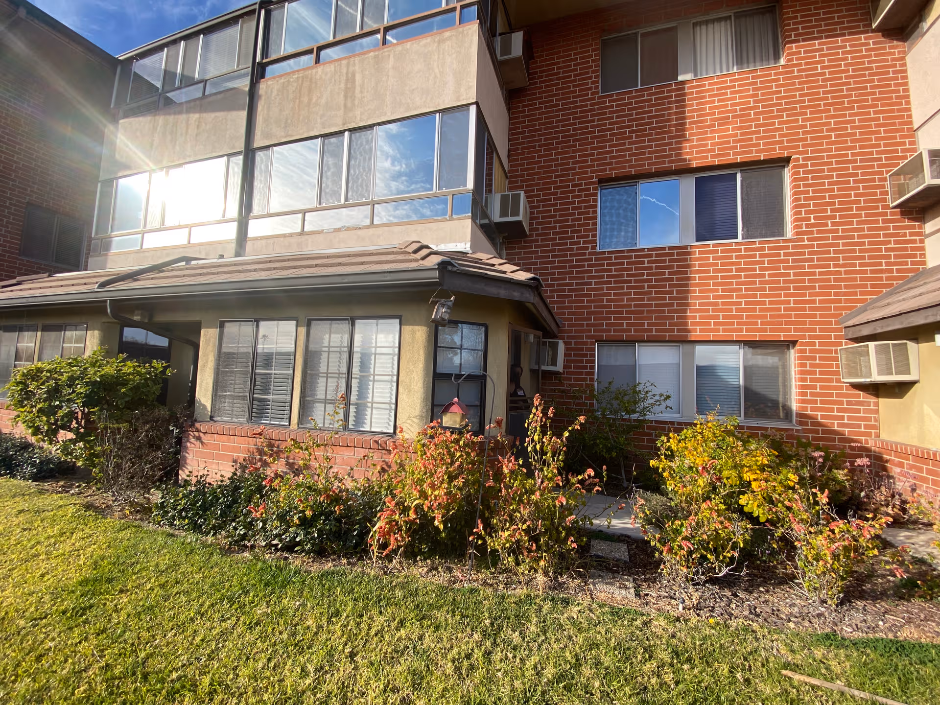 Exterior view of Rowntree Gardens building with brick facade, windows, and landscaped lawn.