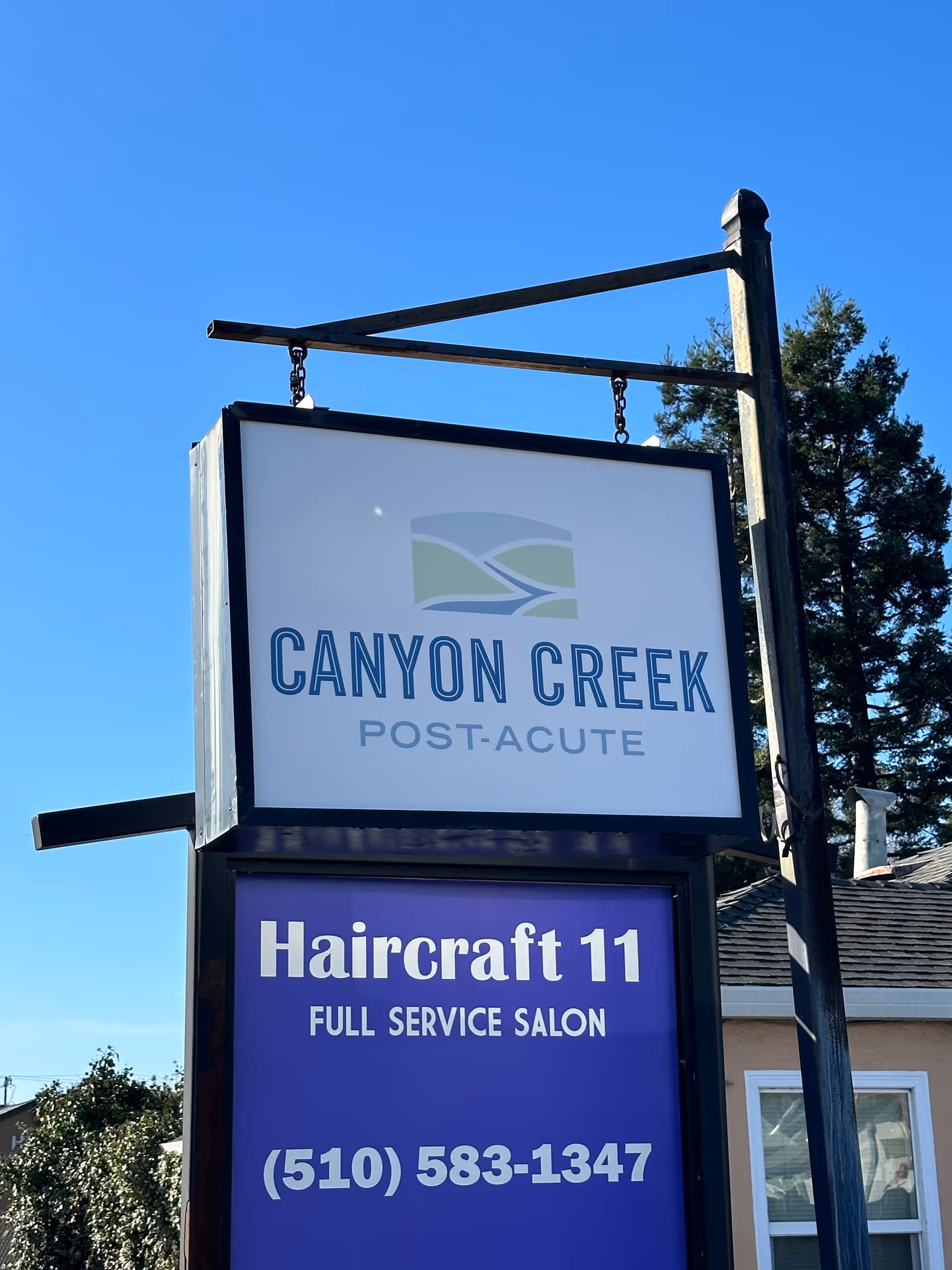 Outdoor building sign reads Canyon Creek Post-Acute and Haircraft 11 salon.