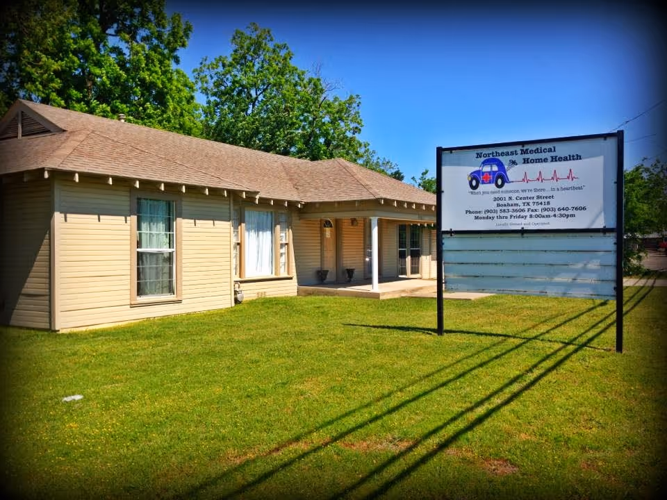 Small beige single-story building with a sign reading Northeast Medical Home Health on a sunny day.